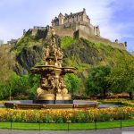 Ross Fountain with Edinburgh Castle in the background, surrounded by vibrant greenery and flowers