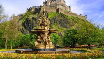 Ross Fountain with Edinburgh Castle in the background, surrounded by vibrant greenery and flowers