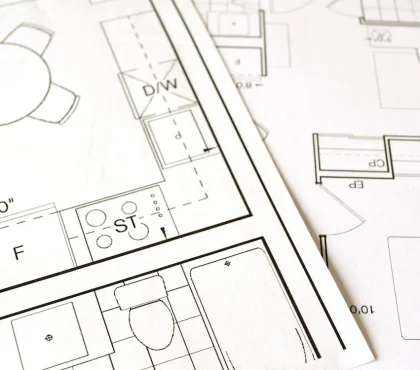 Architectural floor plan with kitchen and bathroom layouts on white paper